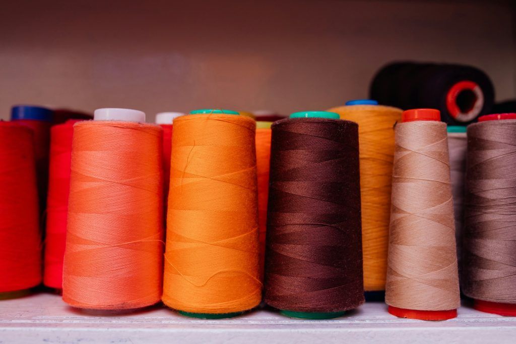 Different colorful thread spools for the weaving loom,